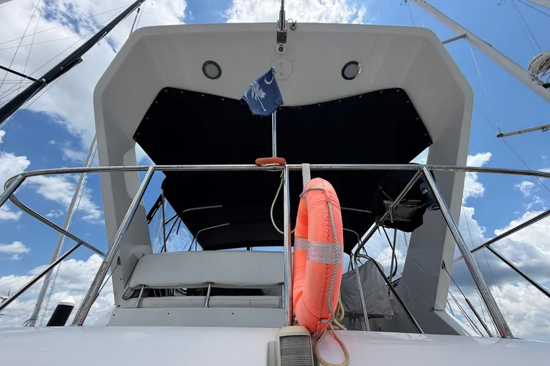 Slide: The Image of 2005 Ocean Alexander 48 Altus yacht with life preserver, viewed from below against blue sky. - 33