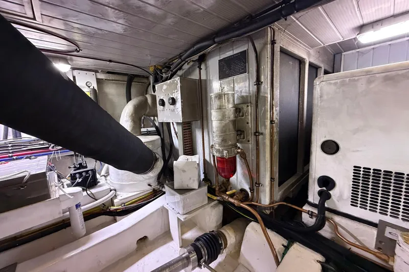 Slide: The Image of Engine room of 2005 Ocean Alexander 48 Altus yacht, showcasing mechanical components and wiring. - 89