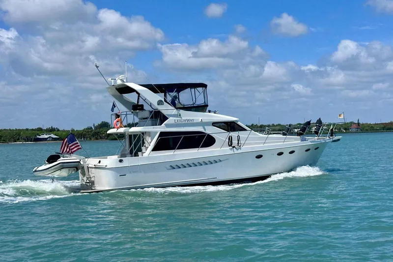 The Image of 2005 Ocean Alexander 48 Altus yacht cruising on a sunny day with American flag. - 1