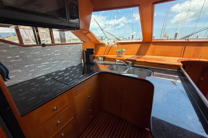 Slide: The Image of Luxurious 2005 Ocean Alexander 48 Altus yacht kitchen with sleek countertops and panoramic windows. - 43