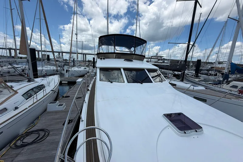 Slide: The Image of 2005 Ocean Alexander 48 Altus yacht docked at marina under cloudy sky. - 20