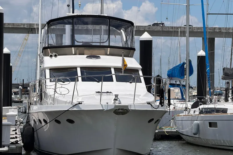 Slide: The Image of 2005 Ocean Alexander 48 Altus yacht docked at marina, clear sky background. - 6