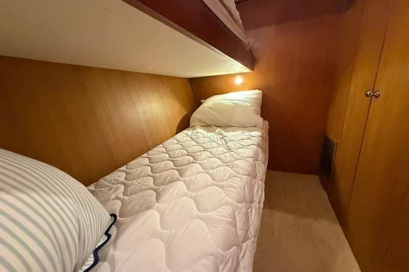 Slide: The Image of Cozy cabin interior of 2005 Ocean Alexander 48 Altus yacht with single bed and wooden paneling. - 62