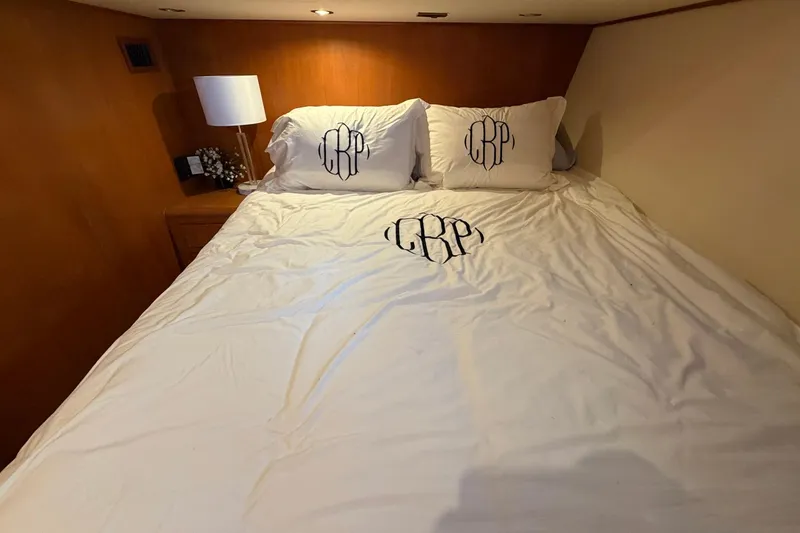 Slide: The Image of Luxurious bedroom interior of 2005 Ocean Alexander 48 Altus yacht with monogrammed bedding. - 59