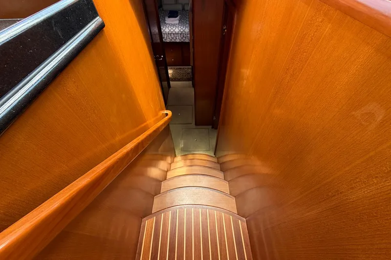 Slide: The Image of Staircase inside 2005 Ocean Alexander 48 Altus yacht, featuring polished wood and elegant design. - 51