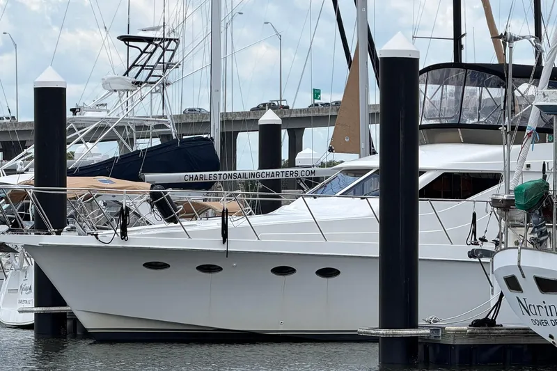Slide: The Image of 2005 Ocean Alexander 48 Altus yacht docked at marina with sailing charters sign. - 5