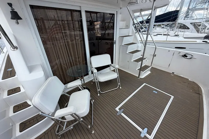 Slide: The Image of Deck of 2005 Ocean Alexander 48 Altus yacht with chairs and stairs. - 25