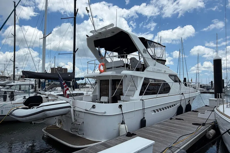 Slide: The Image of 2005 Ocean Alexander 48 Altus yacht docked at marina under blue sky. - 7