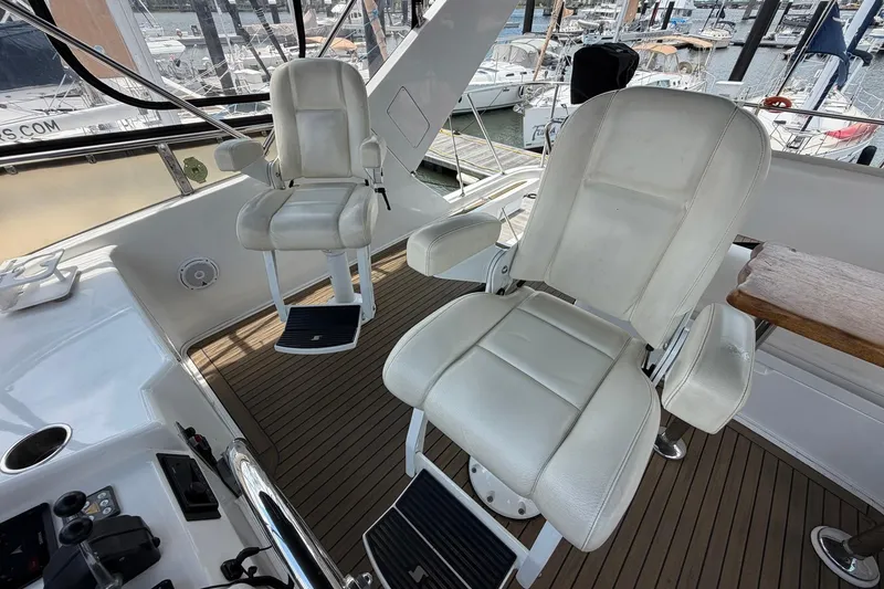 Slide: The Image of Captain's chairs on 2005 Ocean Alexander 48 Altus yacht, docked at marina. - 35