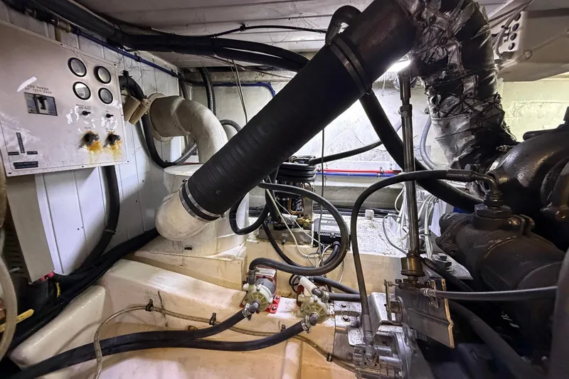 Slide: The Image of Engine room of 2005 Ocean Alexander 48 Altus yacht, showcasing mechanical components and wiring. - 84