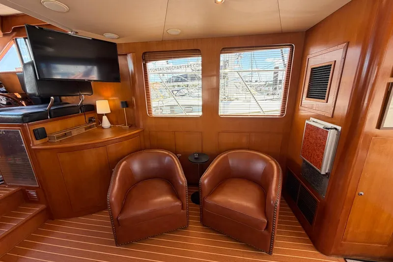Slide: The Image of Luxurious interior of 2005 Ocean Alexander 48 Altus yacht with leather chairs and wood paneling. - 41