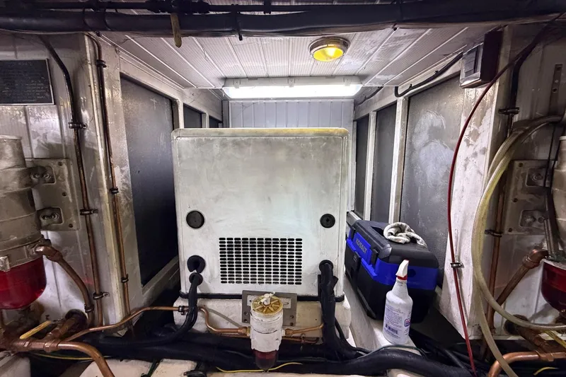Slide: The Image of Engine room of 2005 Ocean Alexander 48 Altus yacht, featuring equipment and maintenance tools. - 88