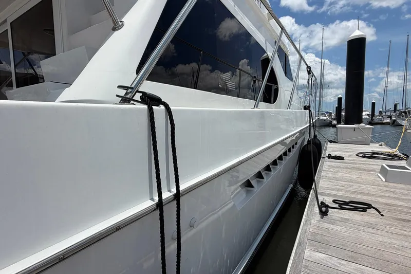 Slide: The Image of 2005 Ocean Alexander 48 Altus yacht docked at marina under blue sky. - 10