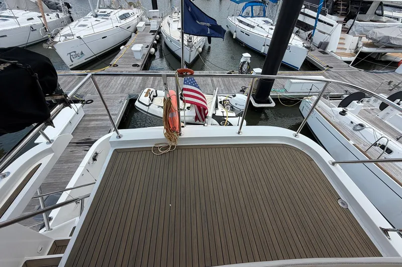 Slide: The Image of 2005 Ocean Alexander 48 Altus yacht docked at marina with American flag. - 31