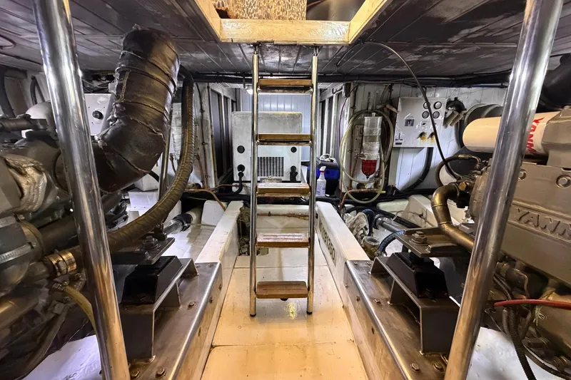 Slide: The Image of Engine room of 2005 Ocean Alexander 48 Altus yacht, featuring mechanical components and ladder. - 82