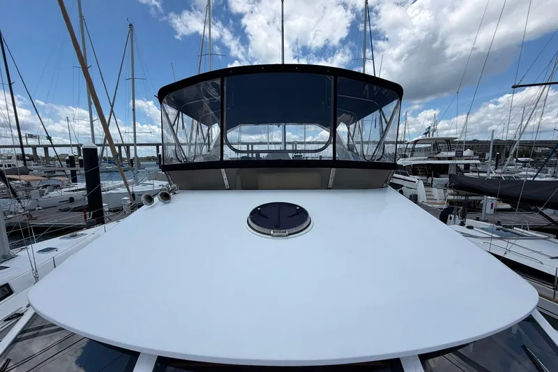 Slide: The Image of 2005 Ocean Alexander 48 Altus yacht docked at marina under blue sky. - 21