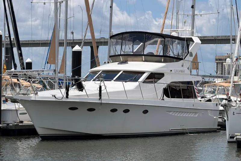 Slide: The Image of 2005 Ocean Alexander 48 Altus yacht docked at marina, surrounded by sailboats. - 2