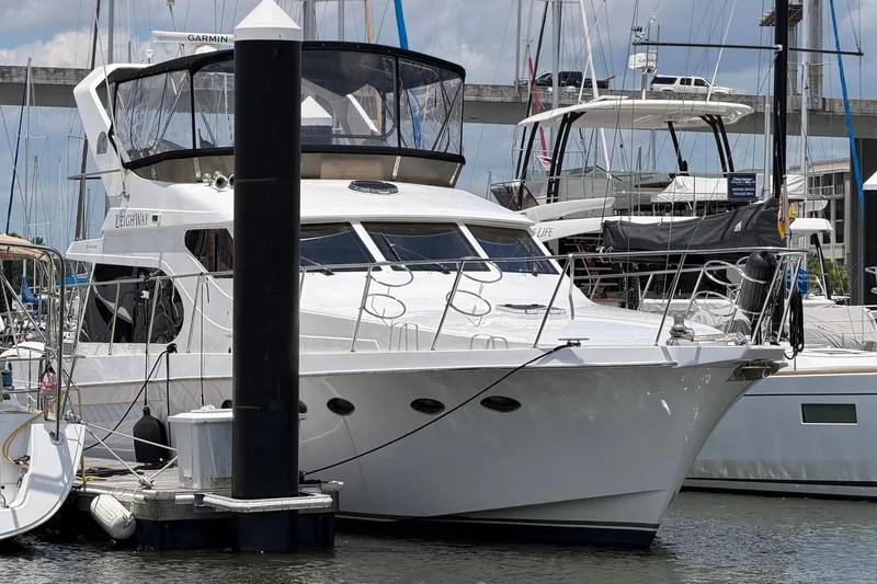 Slide: The Image of 2005 Ocean Alexander 48 Altus yacht docked at marina, surrounded by other boats. - 4