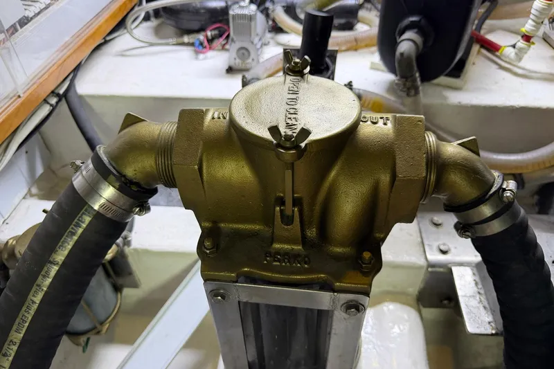 Slide: The Image of Engine room detail of a 2005 Ocean Alexander 48 Altus yacht, featuring brass plumbing components. - 87