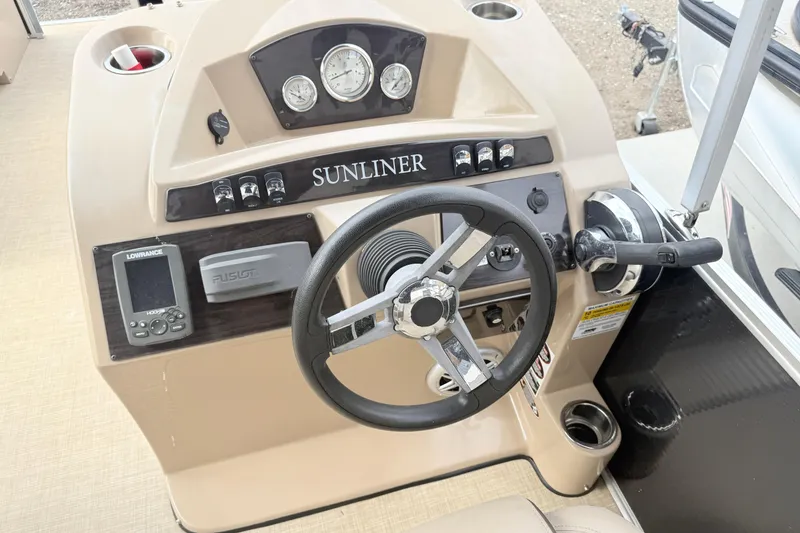 Slide: The Image of 2017 Harris Super Sunliner 200 boat dashboard with steering wheel and control panel. - 7