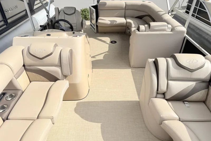 Slide: The Image of Luxurious interior of a 2017 Harris Super Sunliner 200 pontoon boat with beige seating. - 10