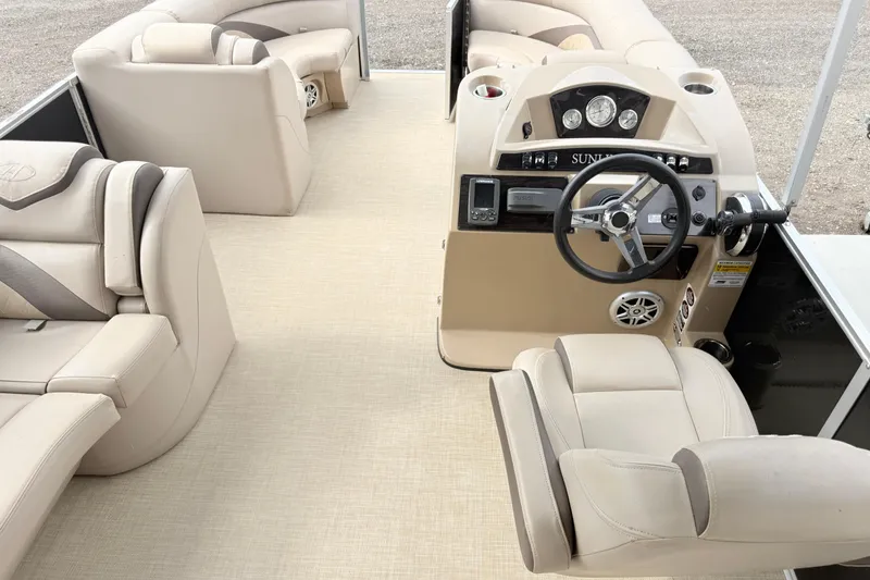 Slide: The Image of Interior of a 2017 Harris Super Sunliner 200 pontoon boat with beige seating and helm. - 6