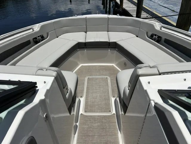 Slide: The Image of The image shows the bow area of a Sea Ray SLX 310 Outboard with gray upholstery. - 15