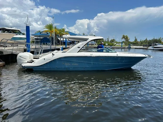 Slide: The Image of A 2021 Sea Ray SLX 310 Outboard is docked in the water. - 29