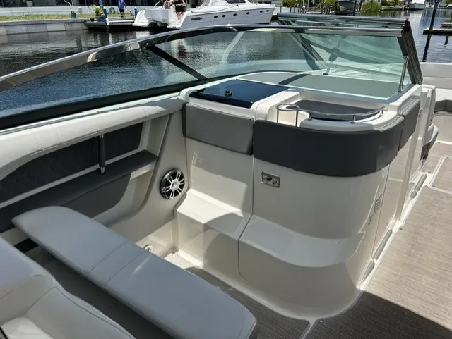 Slide: The Image of The image shows the cockpit of a 2021 Sea Ray SLX 310 Outboard with sleek seating and modern design. - 13