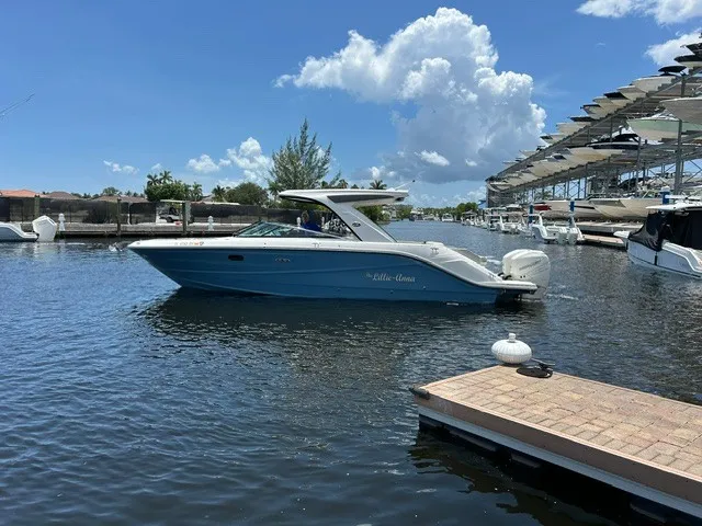 Slide: The Image of 2021 Sea Ray SLX 310 Outboard in a sunny marina. - 27