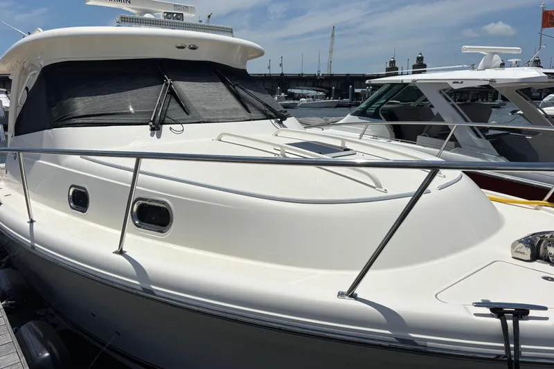 Slide: The Image of 2012 Pursuit 345 OS Foredeck - Windshield Sun Screen/ Hand Rails/ Bow Cushion Tracks/LED Light Bar on Roof/Garmin Open Array Radar Scanner - 25