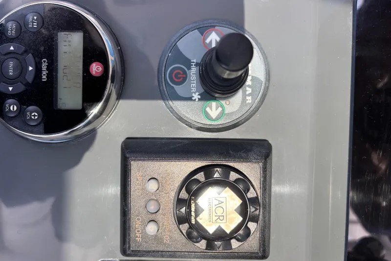 Slide: The Image of Control panel of a 2012 Pursuit OS 345 Offshore boat with Clarion audio system, ACR remote controlled spotlight and a Newmar Bow Thruster control - 10