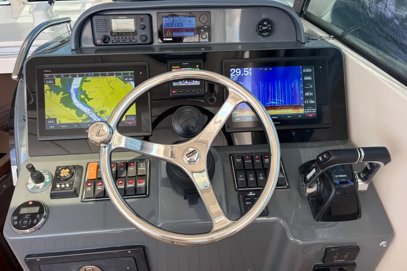 Slide: The Image of Dashboard of a 2012 Pursuit OS 345 Offshore boat with navigation and control systems. - 5