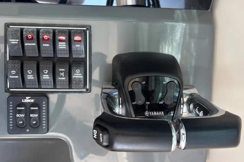 Slide: The Image of Control panel of a 2012 Pursuit OS 345 Offshore boat with Yamaha throttles and Lenco Trim Tab control with position indicators - 9