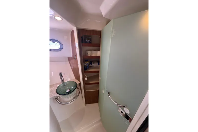 Slide: The Image of 2012 Pursuit 345 OS Acrylic Bi-fold door on linen cabinet  opens to form shower stall door - 50