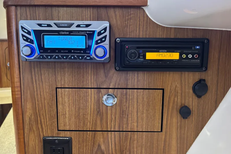 Slide: The Image of 2012 Pursuit 345 OS Entertainment center with Clarion Stereo and Jensen DVD player - 43