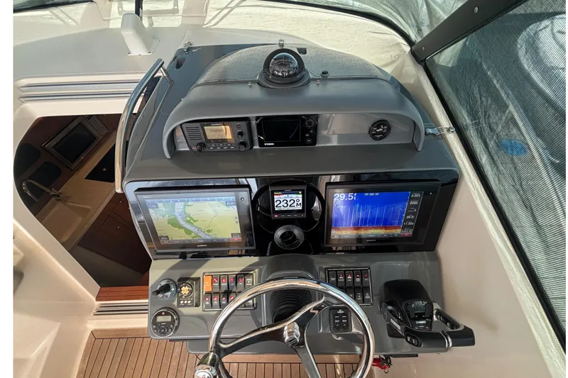 Slide: The Image of Helm of 2012 Pursuit OS 345 Offshore boat with navigation screens and controls. - 4
