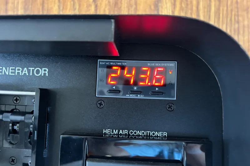 Slide: The Image of Digital multimeter display on 2012 Pursuit OS 345 Offshore boat showing 243.6 volts. - 34