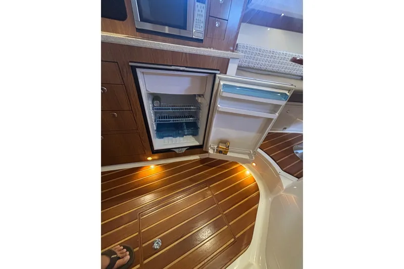 Slide: The Image of 2012 Pursuit 345 OS Dual Voltage Dometic Refrigerator in Galley - 47