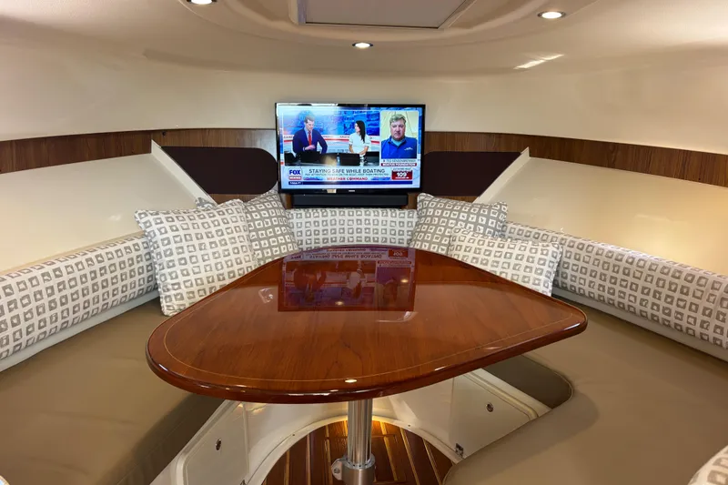 Slide: The Image of 2012 Pursuit 345 OS Forward settee with electrically actuated table top that lowers to form a large berth - 37