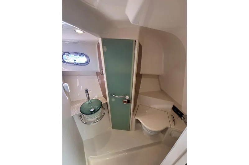 Slide: The Image of 2012 Pursuit 345 OS Head/Shower Compartment with Bi-fold Acrylic Door/Vessel Sink/Hinged Seat over toilet - 49