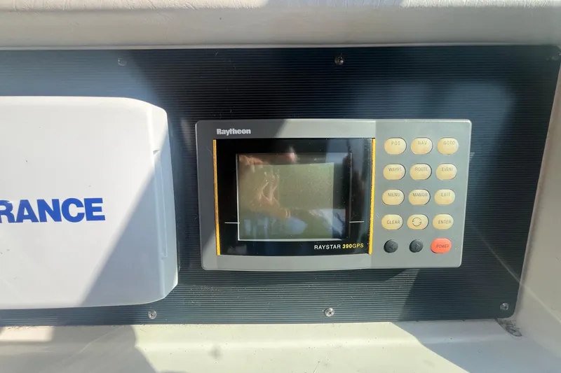 Slide: The Image of Raytheon Raystar 390 GPS on 1994 Sea Ray 330 Express Cruiser dashboard. - 15