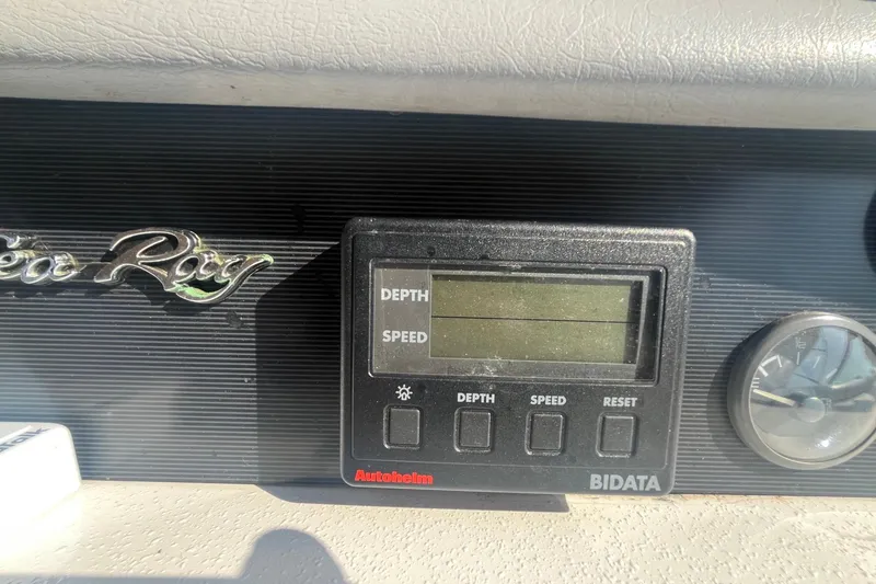 Slide: The Image of Dashboard of a 1994 Sea Ray 330 Express Cruiser with depth and speed display. - 16