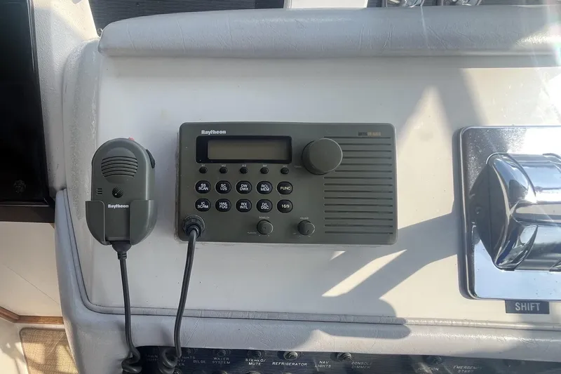 Slide: The Image of Raytheon marine radio and microphone on 1994 Sea Ray 330 Express Cruiser dashboard. - 17
