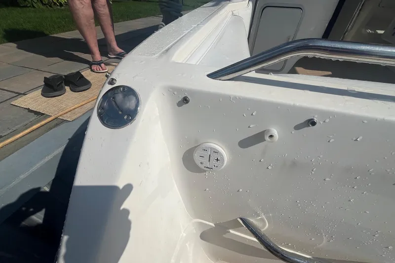 Slide: The Image of 1994 Sea Ray 330 Express Cruiser deck with wet surface and control panel. - 20