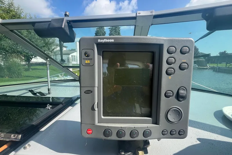 Slide: The Image of Raytheon radar display on 1994 Sea Ray 330 Express Cruiser, docked by a scenic waterfront. - 19