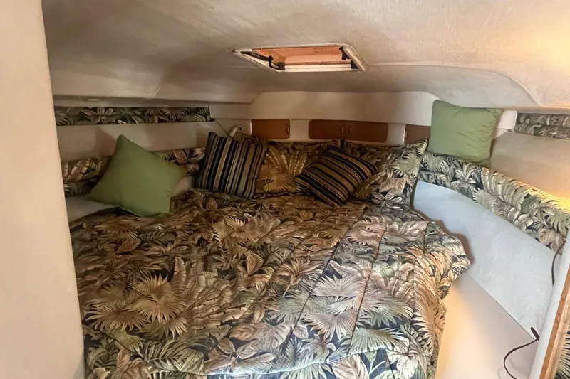 Slide: The Image of Cozy cabin interior of 1994 Sea Ray 330 Express Cruiser with tropical bedding and pillows. - 25