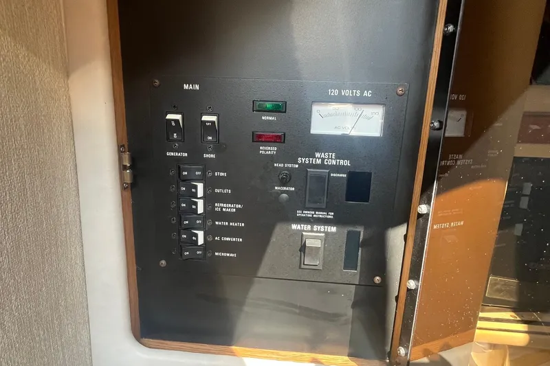 Slide: The Image of Electrical control panel of a 1994 Sea Ray 330 Express Cruiser, featuring various switches and indicators. - 30