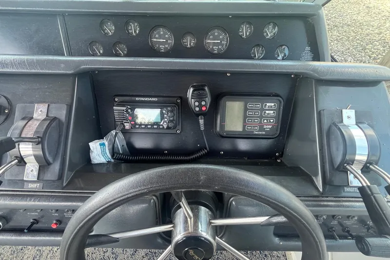 Slide: The Image of 1993 Sea Ray Sundancer 330 helm with gauges, controls, and communication equipment. - 9