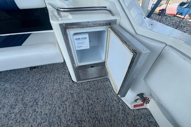 Slide: The Image of Open ice maker on 1993 Sea Ray Sundancer 330 boat, showing interior and surrounding seating area. - 6